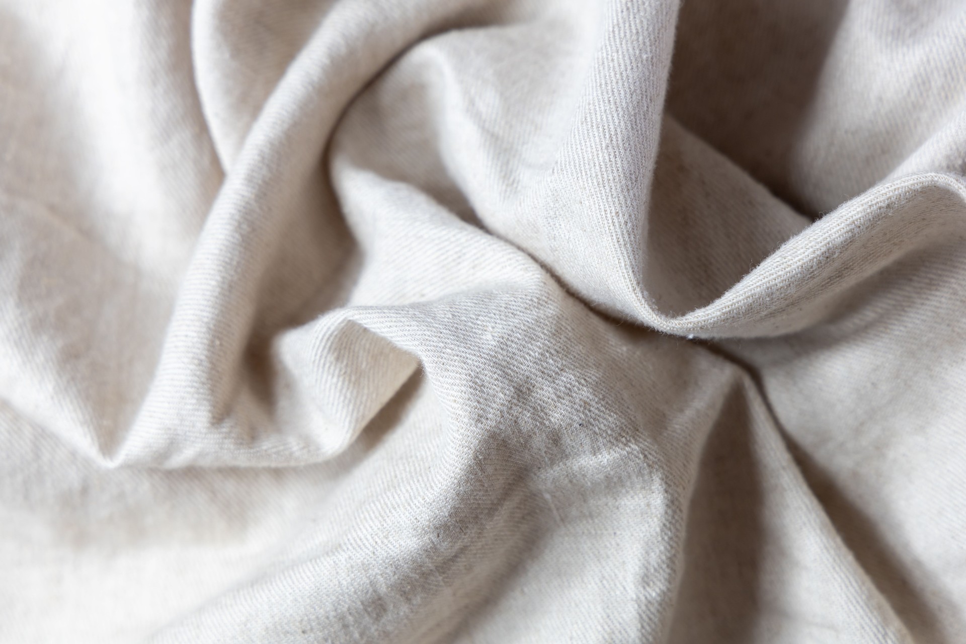 Close-up of soft, neutral-toned linen fabric symbolizing high-quality guest essentials, comfort, and elegant Airbnb styling.